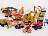 de nombreux engins de chantier miniatures posés sur une surface blanche