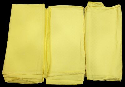 four yellow napkins on a black background with a black background