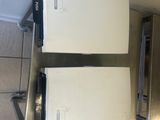 two microwaves sitting on a counter in a kitchen