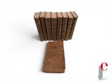 a stack of old books sitting on top of a book stand