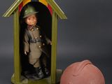toy soldier in a green house with a helmet next to it