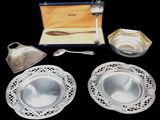 a silver plate with a spoon and a silver plate with a spoon and a silver plate with a spoon and a silver plate with a spoon and a spoon
