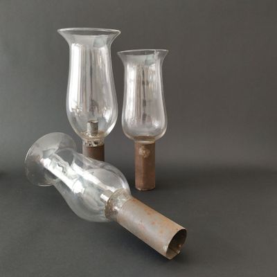 two empty glass vases sitting on top of a table next to each other