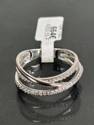 a close up of a diamond ring on a black surface
