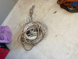 a ball of rope on the floor next to a bag