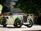 a green and white vintage car parked in front of a building