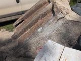 a white van parked next to a pile of junk
