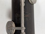 a close up of a flute with a key on it