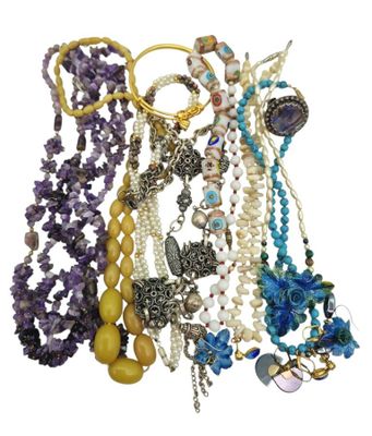a lot of necklaces and bracelets on a white background