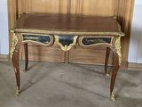 a wooden table with a black and gold design on it