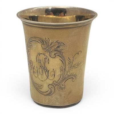 a gold cup with a horse on it on a white surface