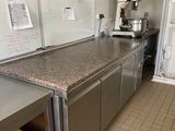a kitchen with a counter and a refrigerator in it