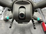 a small camera attached to the back of a small drone