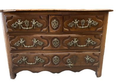 an image of a wooden chest of drawers with ornate handles