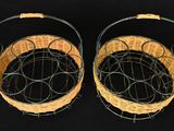 pair of woven baskets on a black background with a black background