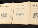 four books are lined up on a black table