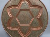 a close up of a metal plate with a star of david on it