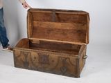a man standing next to an old trunk that has been turned into a chest