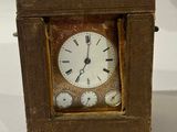 a small wooden clock that is sitting on a table