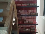 many boxes of cigarettes on the shelves in the store