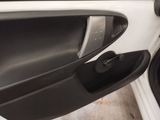 a close up of a door handle on a white car