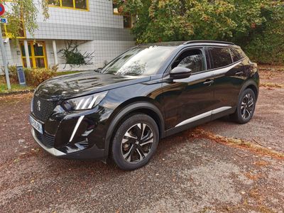 the black suv is parked in front of a building