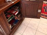 a wooden cabinet with a door open in a living room