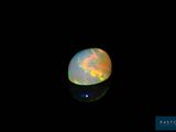 a close up of a white fire opal in the dark