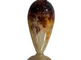 a glass vase sitting on a pedestal on a white background