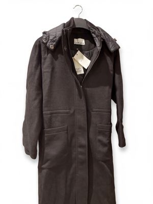 an image of a coat hanging on a hanger on a wall