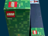 two boxes of legos sitting next to each other on a table