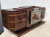 a wooden cabinet with a clock on top of it
