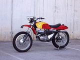 a red and yellow motorcycle parked in a parking lot