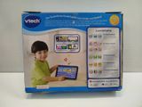 a box with a picture of a child playing with a tablet