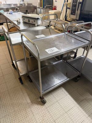 stainless steel tables and chairs in a large commercial kitchen