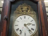 a grandfather clock that is in the middle of a room