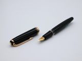 a pen and a ballpoint pen sitting on top of each other