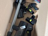 a cardboard box with a vacuum and other items in it