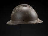 a close up of a helmet on a stand against a black background