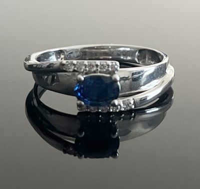 a ring with a blue stone and diamonds on it