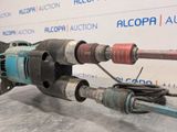 a drill that is sitting on a table next to a wall