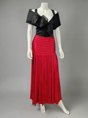 a red pleaed skirt with a black top and black top