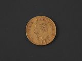 a close up of a gold coin on a black surface