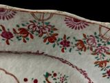 a plate with a floral design on it on a table