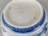 a blue and white bowl on a white table