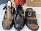 three pairs of men ' s shoes are lined up on a table