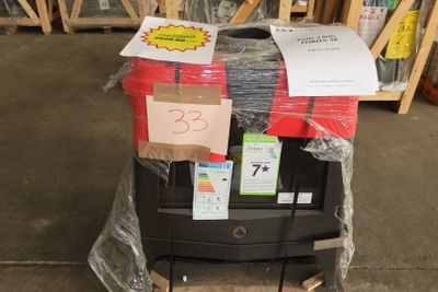 a stack of luggage sitting on top of a cart in a warehouse