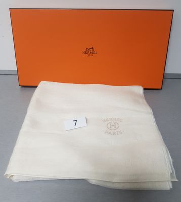 an orange box with a white blanket and a white towel