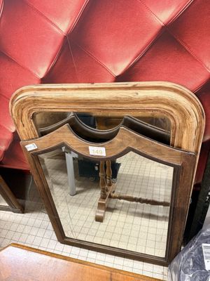a mirror sitting on a table in a room