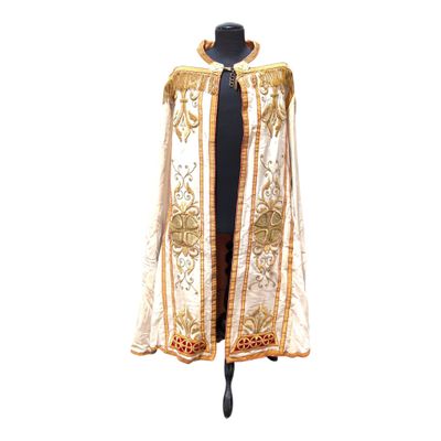 an image of a white and gold cape on a mannequin